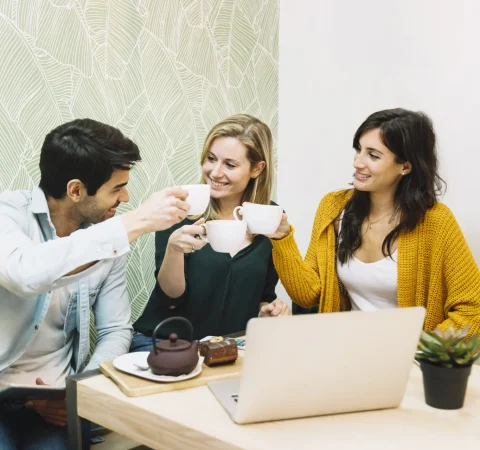 smiling-friends-clinking-cups-tea